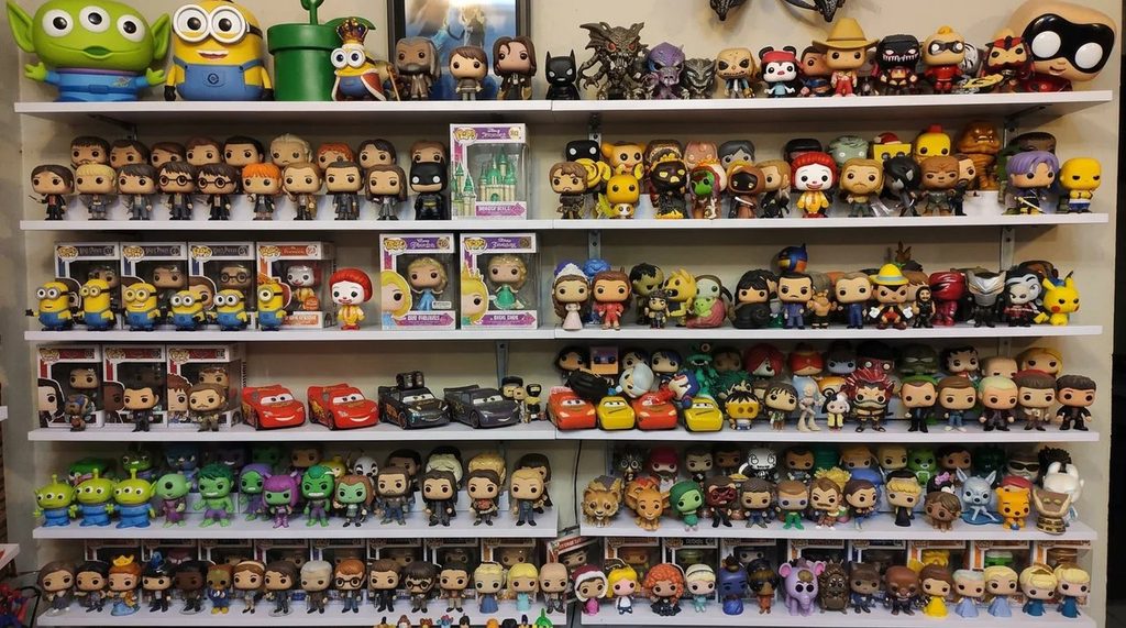 Large collection of funko pops sitting on a collector's shelf.