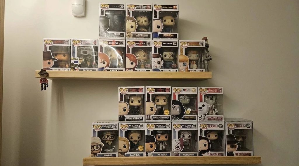 Funko Pop Collection displayed on mounted wall shelves.