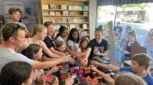 Group of People Reaching for Needohs in a toy store