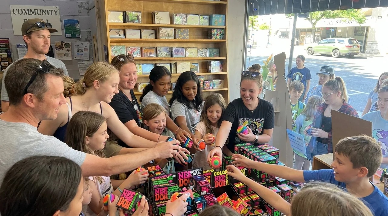 Group of People Reaching for Needohs in a toy store