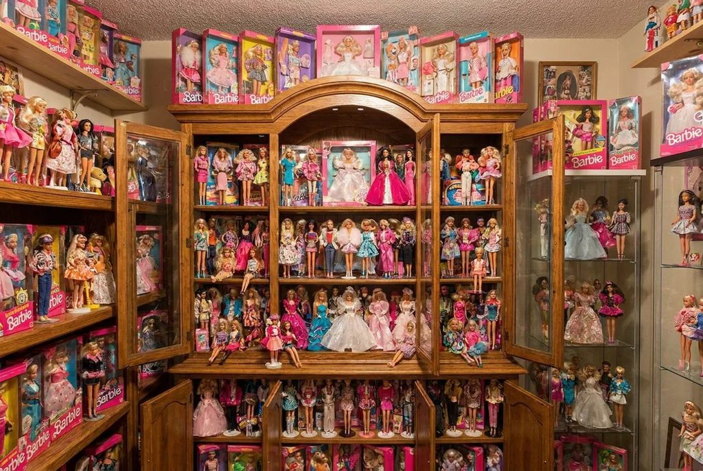 a big collection of barbie dolls in a closet.