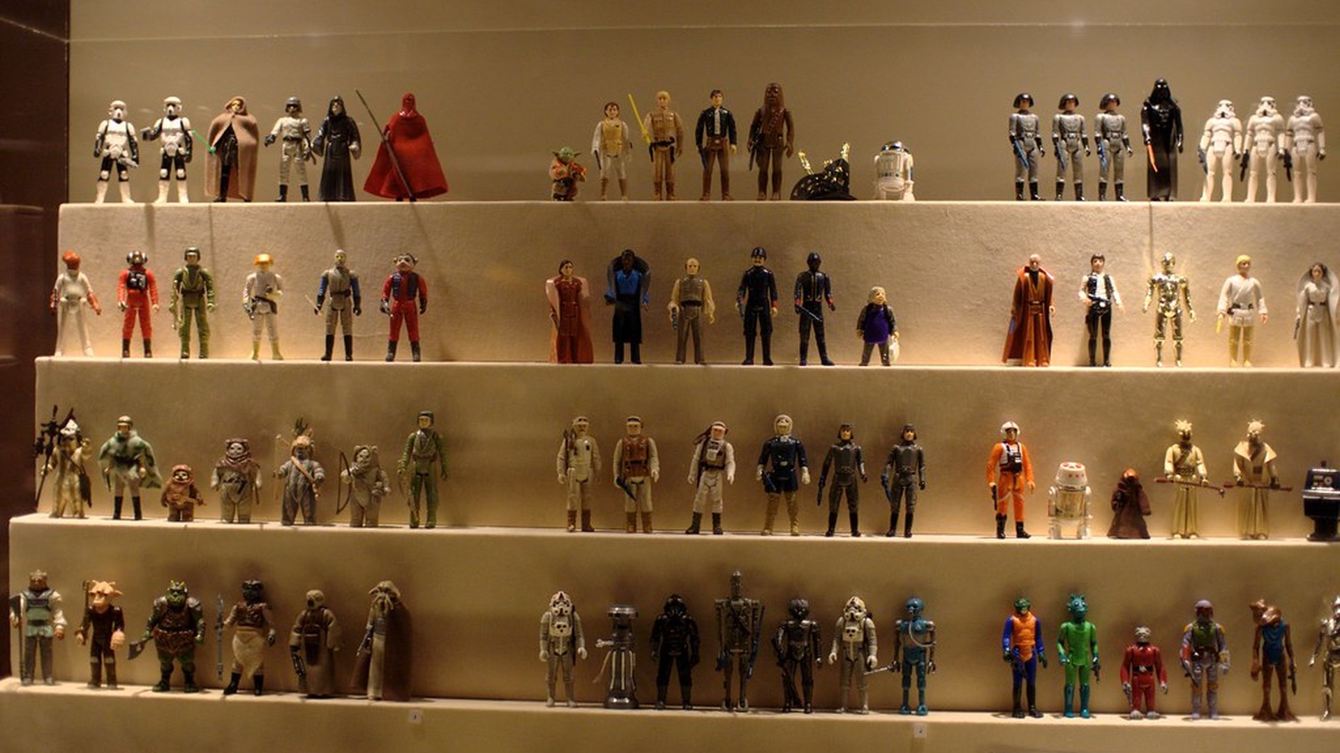 Vintage Kenner Star Wars action figures in a museum-style display case
